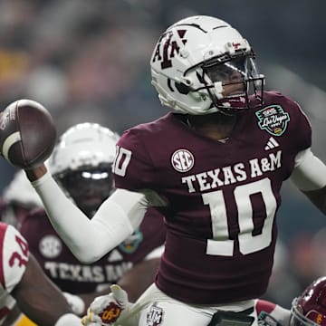 Dec 27, 2024; Las Vegas, NV, USA; Texas A&M Aggies quarterback Marcel Reed (10) throws the ball against Southern California Trojans cornerback John Humphrey (19) in the first half at Allegiant Stadium. Mandatory Credit: Kirby Lee-Imagn Images