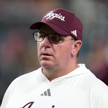 Dec 27, 2024; Las Vegas, NV, USA; Texas A&M Aggies head coach Mike Elko reacts against the Southern California Trojans in the first half at Allegiant Stadium. Mandatory Credit: Kirby Lee-Imagn Images