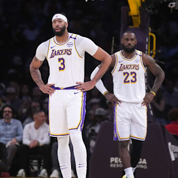 Dec 15, 2024; Los Angeles, California, USA; Los Angeles Lakers forward Anthony Davis (3) and forward LeBron James (23) react in the first half against the Memphis Grizzlies at Crypto.com Arena. Mandatory Credit: Kirby Lee-Imagn Images