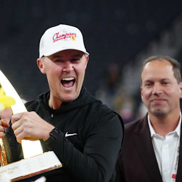 Dec 27, 2024; Las Vegas, NV, USA; Southern California Trojans head coach Lincoln Riley holds the championship trophy after the game against the Texas A&M Aggies at Allegiant Stadium. Mandatory Credit: Kirby Lee-Imagn Images