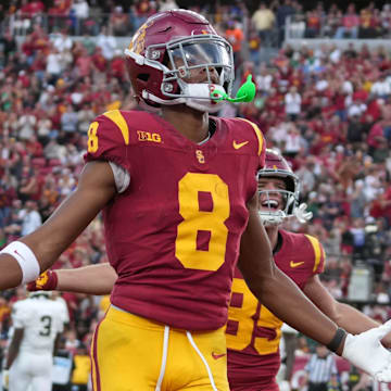 Nov 30, 2024; Los Angeles, California, USA; Southern California Trojans wide receiver Ja'Kobi Lane (8) celebrates after scoring on a 6-yard touchdown reception against the Notre Dame Fighting Irish in the second half at United Airlines Field at Los Angeles Memorial Coliseum. Mandatory Credit: Kirby Lee-Imagn Images