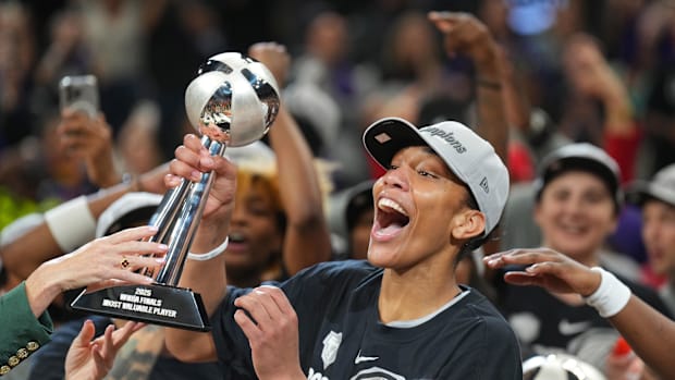 A photo of A'ja Wilson holding the championship troph