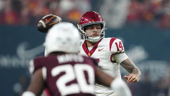 Dec 27, 2024; Las Vegas, NV, USA; Southern California Trojans quarterback Jayden Maiava (14) throws the ball against Texas A&M Aggies defensive back BJ Mayes (20) in the first half at Allegiant Stadium. Mandatory Credit: Kirby Lee-Imagn Images