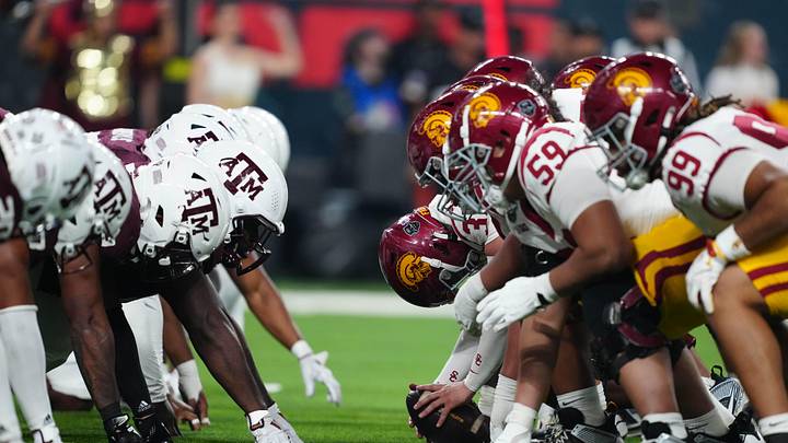 Dec 27, 2024; Las Vegas, NV, USA; Helmets at the line fo scrimmage as DUPLICATE***Southern California Trojans long snapper Hank Pepper (31) snaps the ball against the Texas A&M Aggies at Allegiant Stadium. Mandatory Credit: Kirby Lee-Imagn Images
