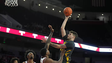 Jan 14, 2025; Los Angeles, California, USA; Iowa Hawkeyes forward Owen Freeman (32) shoots the ball against Southern California Trojans forward Rashaun Agee (12) in the first half at Galen Center. Mandatory Credit: Kirby Lee-Imagn Images