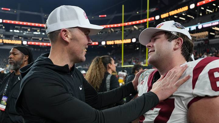 Dec 27, 2024; Las Vegas, NV, USA; Southern California Trojans head coach Lincoln Riley embraces offensive lineman Kilian O'Connor (67) after the game against the Texas A&M Aggies at Allegiant Stadium. Mandatory Credit: Kirby Lee-Imagn Images