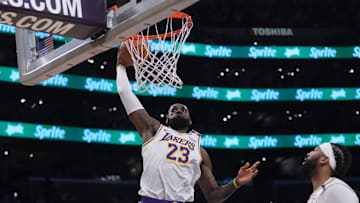 Dec 15, 2024; Los Angeles, California, USA; Los Angeles Lakers forward LeBron James (23) dunks the ball against the Memphis Grizzlies in the first half at Crypto.com Arena. Mandatory Credit: Kirby Lee-Imagn Images