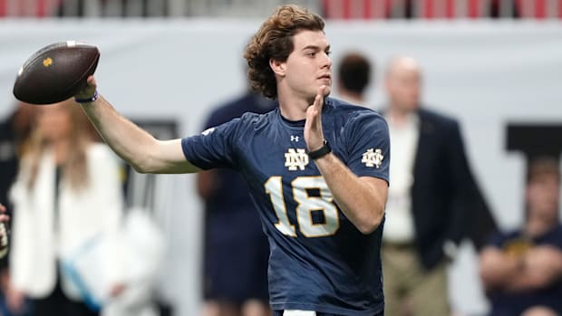 Steve Angeli throws a pass at practice ahead of the 2025 National Championship game between Notre Dame and Ohio Stat
