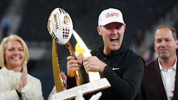Dec 27, 2024; Las Vegas, NV, USA; Southern California Trojans head coach Lincoln Riley holds the championship trophy after the game against the Texas A&M Aggies at Allegiant Stadium. Mandatory Credit: Kirby Lee-Imagn Images