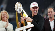 Southern California Trojans head coach Lincoln Riley holds the championship trophy after the game against the Texas A&M Aggies at Allegiant Stadium. 