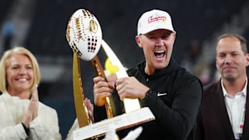 Southern California Trojans head coach Lincoln Riley holds the championship trophy after the game against the Texas A&M Aggies at Allegiant Stadium. 