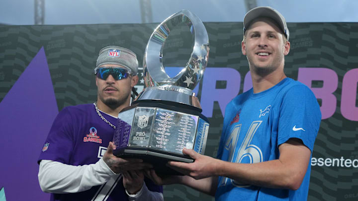 Pro Bowl Games most valuable defensive player NFC cornerback Murphy of the Minnesota Vikings and most valuable offensive player quarterback Goff of the Detroit Lions pose with the championship trophy at Camping World Stadium. 
