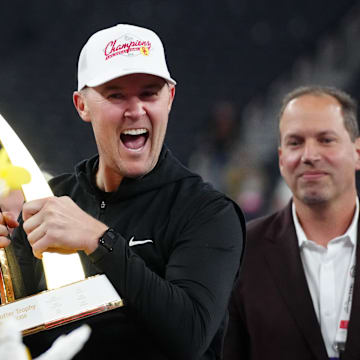 Dec 27, 2024; Las Vegas, NV, USA; Southern California Trojans head coach Lincoln Riley holds the championship trophy after the game against the Texas A&M Aggies at Allegiant Stadium. Mandatory Credit: Kirby Lee-Imagn Images