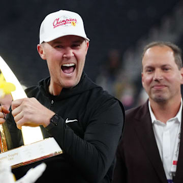 Dec 27, 2024; Las Vegas, NV, USA; Southern California Trojans head coach Lincoln Riley holds the championship trophy after the game against the Texas A&M Aggies at Allegiant Stadium. Mandatory Credit: Kirby Lee-Imagn Images