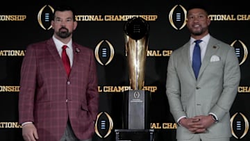 Jan 19, 2025; Atlanta, GA, USA; Ohio State Buckeyes head coach Ryan Day (left) and Notre Dame Fighting Irish head coach Marcus Freeman pose with the College Football Playoff National Championship trophy at press conference at The Westin Peachtree Plaza, Savannah Ballroom. 