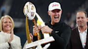 Dec 27, 2024; Las Vegas, NV, USA; Southern California Trojans head coach Lincoln Riley holds the championship trophy after the game against the Texas A&M Aggies at Allegiant Stadium. Mandatory Credit: Kirby Lee-Imagn Images