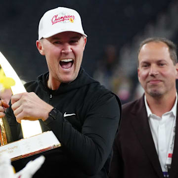 Dec 27, 2024; Las Vegas, NV, USA; Southern California Trojans head coach Lincoln Riley holds the championship trophy after the game against the Texas A&M Aggies at Allegiant Stadium. Mandatory Credit: Kirby Lee-Imagn Images
