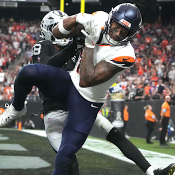 Nov 24, 2024; Paradise, Nevada, USA; Denver Broncos wide receiver Courtland Sutton (14) catches an 18-yard touchdown pass against Las Vegas Raiders cornerback Jack Jones (18) in the third quarter at Allegiant Stadium. 