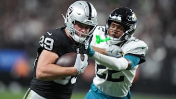 Dec 22, 2024; Paradise, Nevada, USA; Las Vegas Raiders tight end Brock Bowers (89) carries the ball against Jacksonville Jaguars cornerback Jarrian Jones (22) in the second half at Allegiant Stadium. Mandatory Credit: Kirby Lee-Imagn Images