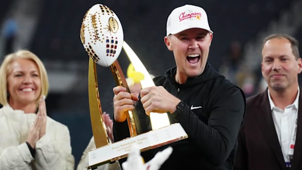 Dec 27, 2024; Las Vegas, NV, USA; Southern California Trojans head coach Lincoln Riley holds the championship trophy after th