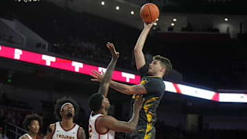 Jan 14, 2025; Los Angeles, California, USA; Iowa Hawkeyes forward Owen Freeman (32) shoots the ball against Southern California Trojans forward Rashaun Agee (12) in the first half at Galen Center. Mandatory Credit: Kirby Lee-Imagn Images
