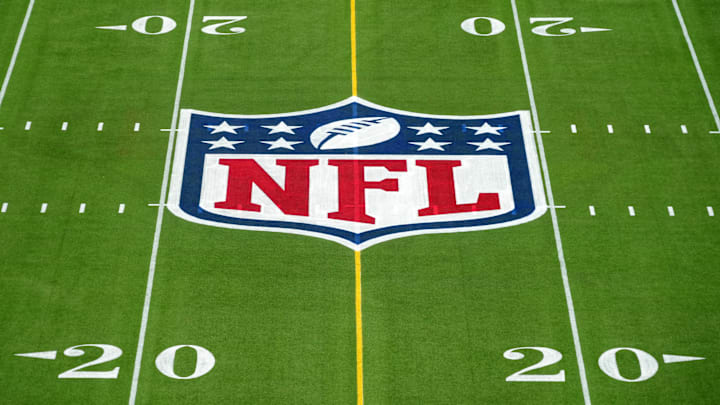 An overall view of the NFL shield logo at midfield on the Camping World Stadium flag football field. 