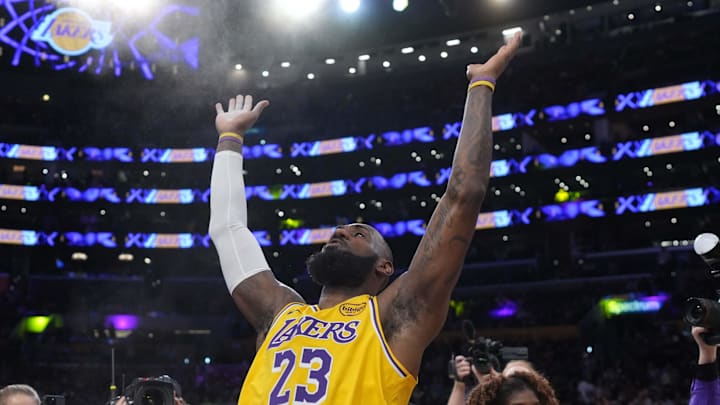 Los Angeles Lakers forward LeBron James throws powdered chalk into the air before a game against the Boston Celtics.