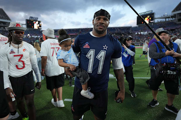 NFC defensive end Micah Parson of the Dallas Cowboys (11) holds his daughter Shatara Parsons after the 2025 Pro Bowl Games.