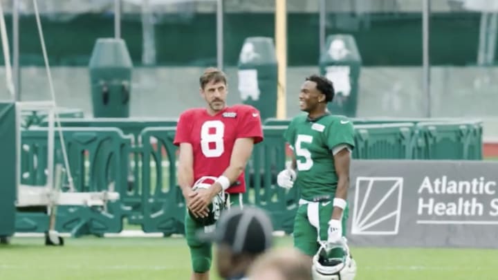 Aaron Rodgers (No. 8) and Garrett Wilson (No. 5) speak while mic'd up during a New York Jets joint practice with the New York Giants on August 21 at the Atlantic Health Training Center. 