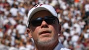 Sep 20, 2025; Blacksburg, Virginia, USA;  Virginia Tech Hokies head coach Phillip Montgomery runs into the stadium before the game against the Wofford Terriers at Lane Stadium. Mandatory Credit: Brian Bishop-Imagn Images