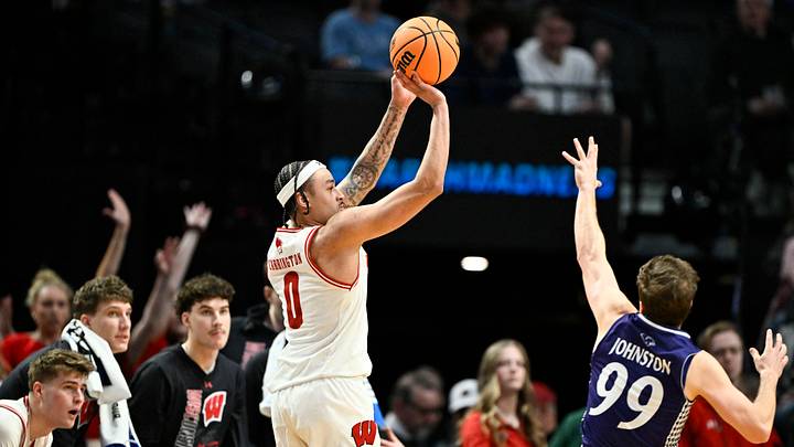 Mar 19, 2026; Portland, OR, USA; Wisconsin Badgers guard Braeden Carrington (0) shoots against High Point Panthers guard Chase Johnston (99) during the second half of a first round game of the men's 2026 NCAA Tournament at Moda Center. Mandatory Credit: Craig Strobeck-Imagn Images