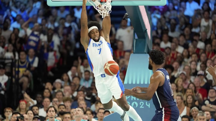 Aug 10, 2024; Paris, France; France power forward Guerschon Yabusele (7) dunks against United States centre Joel Embiid (11) in the first quarter in the men's basketball gold medal game during the Paris 2024 Olympic Summer Games at Accor Arena. Mandatory Credit: Kyle Terada-USA TODAY Sports