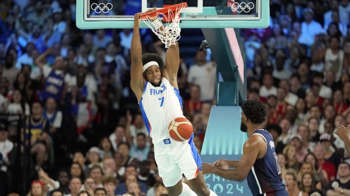 Aug 10, 2024; Paris, France; France power forward Guerschon Yabusele (7) dunks against United States centre Joel Embiid (11) in the first quarter in the men's basketball gold medal game during the Paris 2024 Olympic Summer Games at Accor Arena. Mandatory Credit: Kyle Terada-USA TODAY Sports