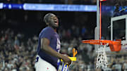 Apr 3, 2023; Houston, TX, USA; Connecticut Huskies forward Adama Sanogo (21) celebrates while cutting down the net after defeating the San Diego State Aztecs in the national championship game of the 2023 NCAA Tournament at NRG Stadium. Mandatory Credit: Bob Donnan-Imagn Images