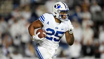 Sep 18, 2021; Provo, Utah, USA; BYU Cougars running back Tyler Allgeier (25) carries the ball in the first quarter against the Arizona State Sun Devils at LaVell Edwards Stadium. Mandatory Credit: Kirby Lee-Imagn Images