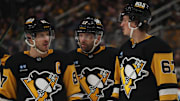 Mar 13, 2025; Pittsburgh, Pennsylvania, USA; Pittsburgh Penguins center Sidney Crosby (87) talks with right wing Bryan Rust (17) and right wing Rickard Rakell (67) against the St. Louis Blues during the third period at PPG Paints Arena. Mandatory Credit: Charles LeClaire-Imagn Images
