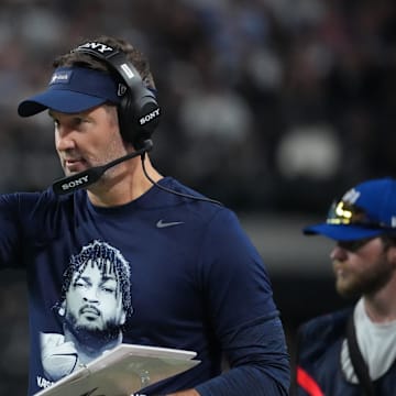 Dallas head coach Brian Schottenheimer, wearing a t-shirt honoring Cowboys defensive end Marshawn Kneeland, against the Las Vegas Raiders