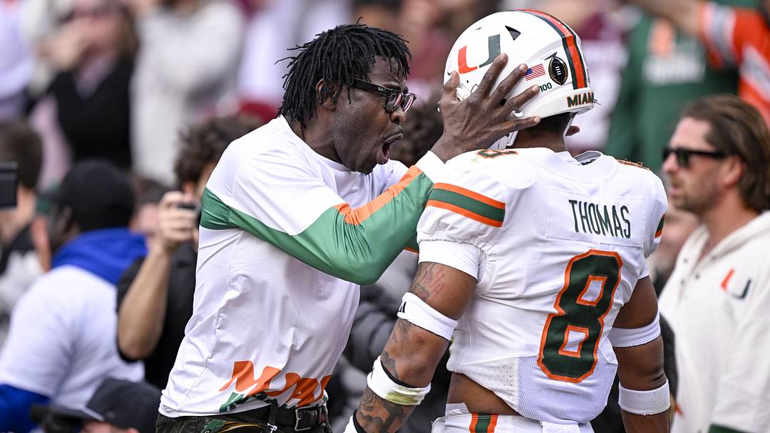 Dec 20, 2025; College Station, TX, USA; Former Miami Hurricanes player Michael Irvin (left) celebrates with Miami Hurricanes defensive back Jakobe Thomas (8) during the game between the Aggies and the Hurricanes at Kyle Field. Mandatory Credit: Jerome Miron-Imagn Images