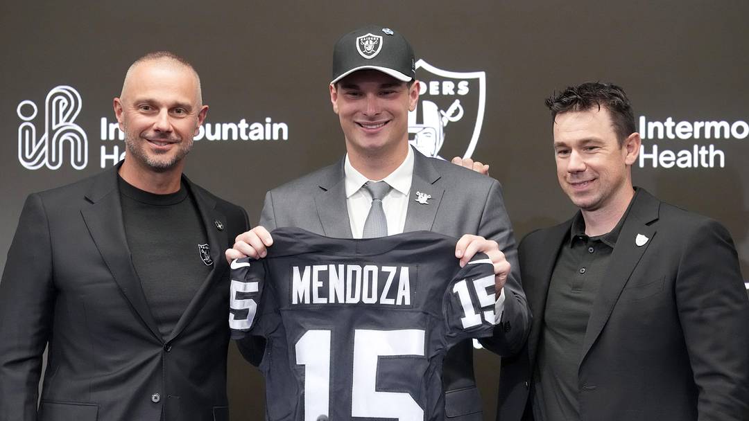 Apr 24, 2026; Henderson, NV, USA; Las Vegas Raiders quarterback Fernando Mendoza (center) poses with general manager John Spytek (left) and head coach Klint Kubiak  at introductory press conference at Intermountain Health Performance Center after being selected as the No. 1 pick in the 2026 NFL Draft. Mandatory Credit: Kirby Lee-Imagn Images
