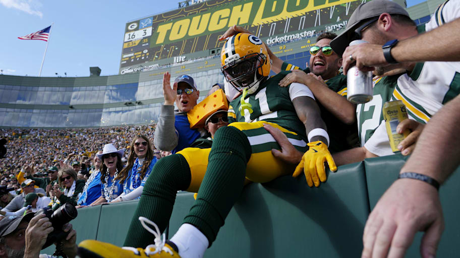 Green Bay Packers wide receiver Jayden Reed celebrates with fans after scoring a touchdown against the Detroit Lions.