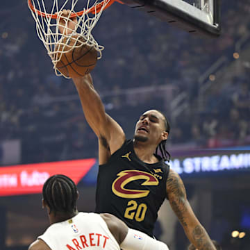 Oct 31, 2025; Cleveland, Ohio, USA; Cleveland Cavaliers forward Jaylon Tyson (20) dunks beside Toronto Raptors forward RJ Barrett (9) in the first quarter at Rocket Arena. Mandatory Credit: David Richard-Imagn Images