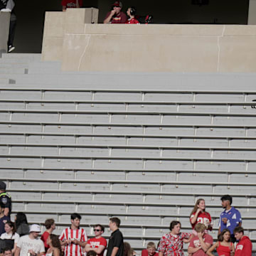 Oct 18, 2025; Madison, Wisconsin, USA; A man has a large seating area to himself during the second quarter of the Wisconsin Badgers - Ohio State football game at Camp Randall Stadium.