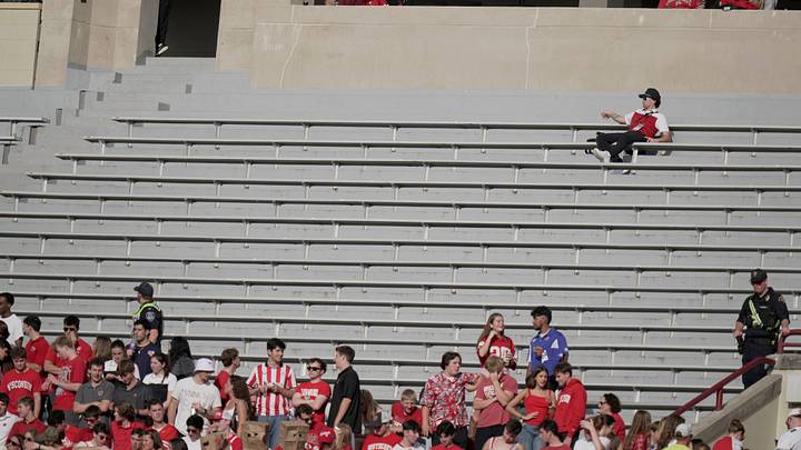 Oct 18, 2025; Madison, Wisconsin, USA; A man has a large seating area to himself during the second quarter of the Wisconsin - Ohio State football game at Camp Randall Stadium.