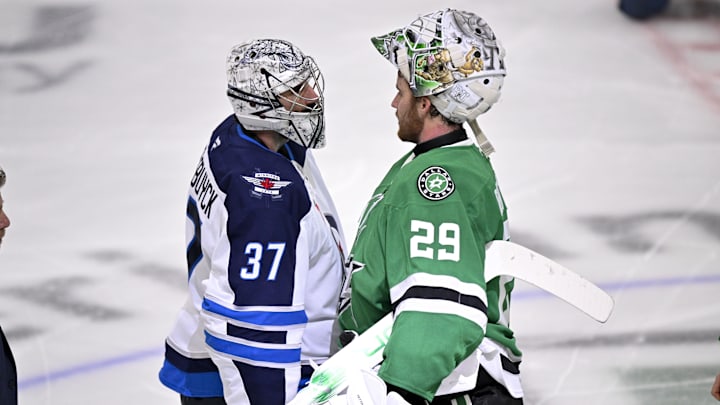 Winnipeg Jets goaltender Connor Hellebuyck shakes hands with Dallas Stars goaltender Jake Oettinger.