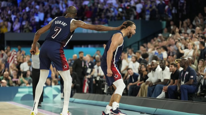 United States guard Stephen Curry (4) celebrates with Kevin Durant (7) in the second half against France in the men's basketball gold medal game during the Paris 2024 Olympic Summer Games at Accor Arena. 