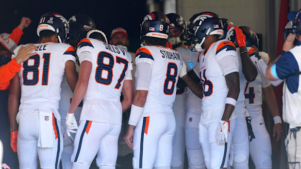 Members of the Denver Broncos offense huddle before the game against the Arizona Cardinals at Empower Field at Mile High. 