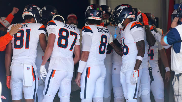 Aug 25, 2024; Denver, Colorado, USA; Members of the Denver Broncos offense huddle before the game against the Arizona Cardinals at Empower Field at Mile High. 