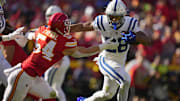 Nov 23, 2025; Kansas City, Missouri, USA; Indianapolis Colts running back Jonathan Taylor (28) runs against Kansas City Chiefs linebacker Leo Chenal (54) in the first quarter at GEHA Field at Arrowhead Stadium. Mandatory Credit: Jay Biggerstaff-Imagn Images
