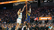 Feb 23, 2024; San Francisco, California, USA; Golden State Warriors forward Jonathan Kuminga (00) shoots against Charlotte Hornets forward Miles Bridges (0) during the second quarter at Chase Center. Mandatory Credit: Darren Yamashita-Imagn Images