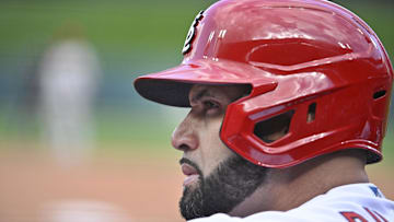 Oct 7, 2022; St. Louis, Missouri, USA; St. Louis Cardinals designated hitter Albert Pujols (5) looks on from the dugout during the sixth inning against the Philadelphia Phillies in game one of the Wild Card series for the 2022 MLB Playoffs at Busch Stadium. Mandatory Credit: Jeff Curry-Imagn Images